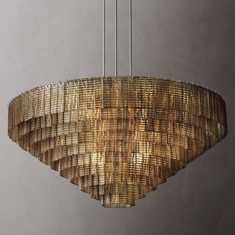 The collection's chandeliers combine traditional glassmaking techniques with modernist style. It is a study in geometric repetition, with textured ribbons of cast glass cascading in concentric circles, casting a warm glow to stunning effect.