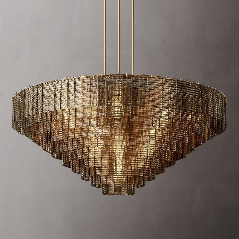 The collection's chandeliers combine traditional glassmaking techniques with modernist style. It is a study in geometric repetition, with textured ribbons of cast glass cascading in concentric circles, casting a warm glow to stunning effect.
