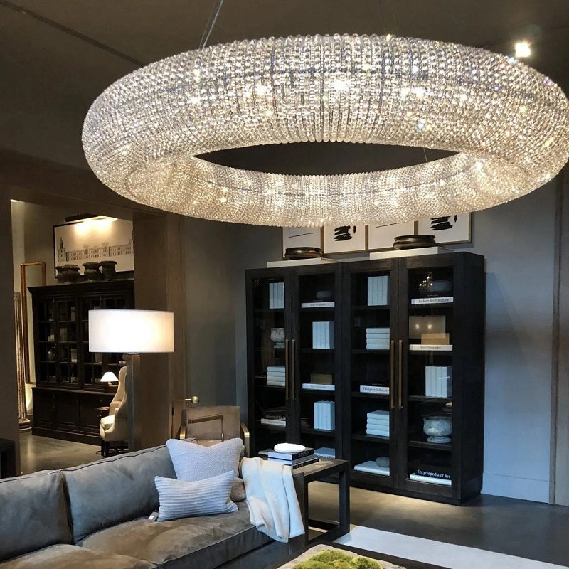Hale Series chandeliers echo the originality of industrial design in the 1920s. Thousands of cut, hand wrapped crystal glass beads wrap around the steel frame to form a floating sphere suspended by steel cables. These beads reflect and refract the light in the room and cast a warm light.
