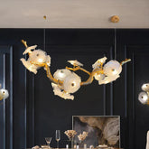 This modern Leaf Glass Flower Linear Chandelier is made of brass and glass. The glass are scattered on the branches, the surface treatment of the branches are also inspired by the tree stem. It's perfect for home decoration. 