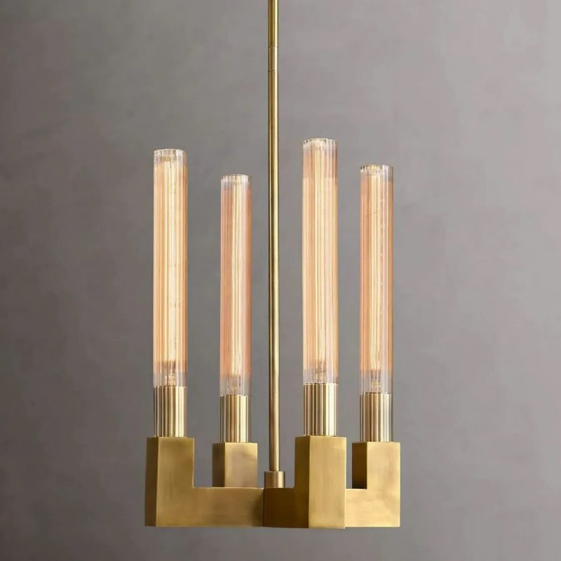 The Lester Chandelier collection features ribbed-glass hurricanes that highlight the beauty of Edison filament bulbs, which emit a warm and cozy glow reminiscent of candlelight. It appears to be both elegant and functional, combining form and function in a sophisticated manner.