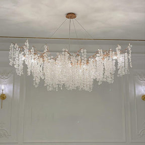 Wisam Branch Chandelier a luxurious chandelier made of brass and glass discs. Inspired by organic nature, this chandelier is suitable for use in the living room or dining room. It is an elegant, attractive and looks like a blossoming tree, making the home fresh and delightful like nature.