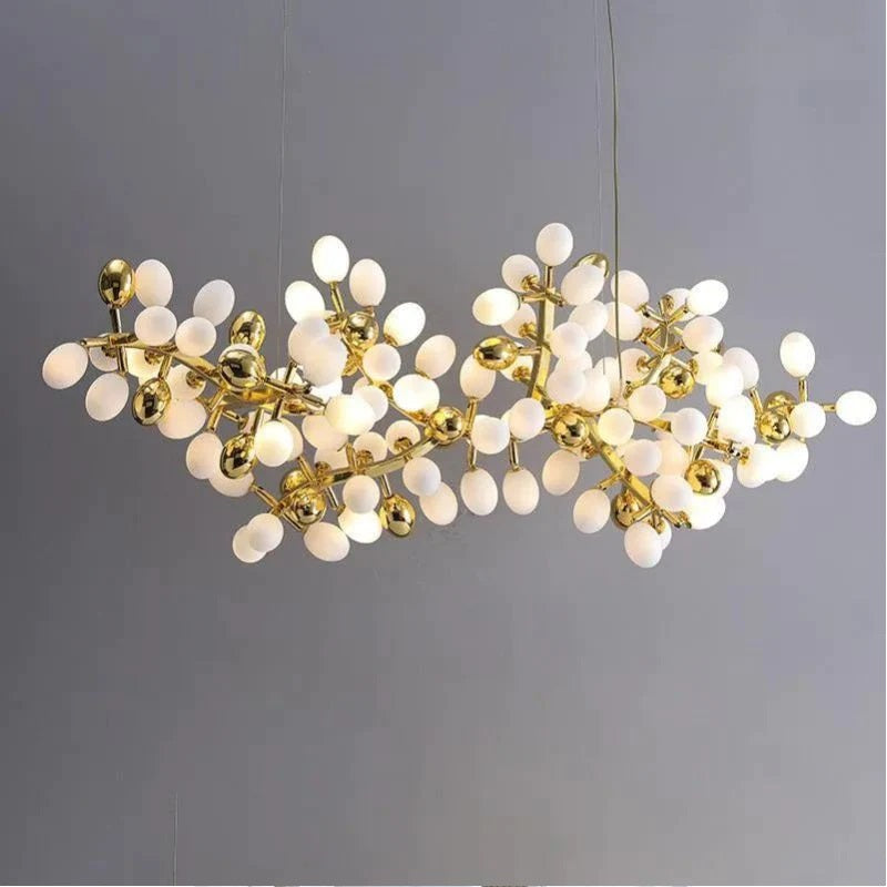 The collection of chandeliers is inspired by the growth dynamics of the vine plant grape. The frame of the branches is handmade and the cups are made of balls in the shape of grapes in milk white and gold. It is an elegant and charming lamp for banquets, living room foyers.