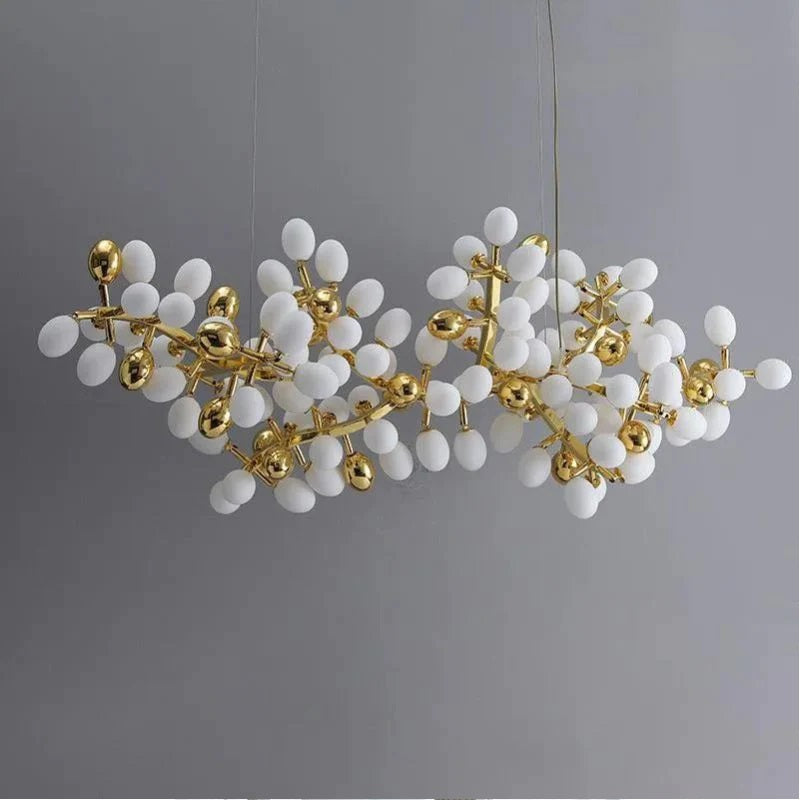 The collection of chandeliers is inspired by the growth dynamics of the vine plant grape. The frame of the branches is handmade and the cups are made of balls in the shape of grapes in milk white and gold. It is an elegant and charming lamp for banquets, living room foyers.