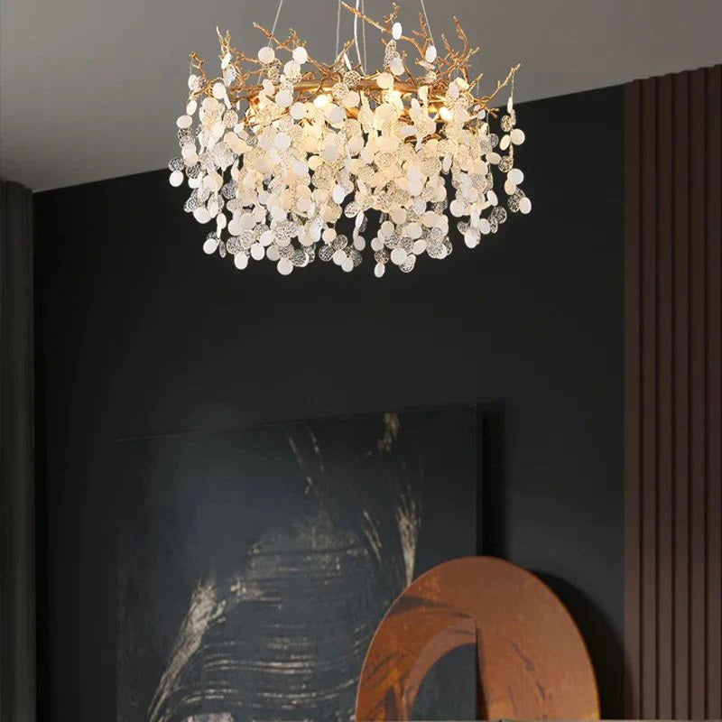 Wisam Round Ring Branch Chandelier a luxurious chandelier made of brass and glass discs. Inspired by organic nature, this chandelier is suitable for use in the living room or dining room. It is an elegant, attractive and looks like a blossoming tree, making the home fresh and delightful like nature.