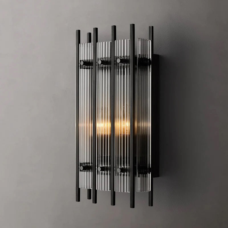 The Sam Collection captures the period's fascination with geometric forms. Hundreds of faceted dynamic prisms subtly refract light, evoking the allure of the industrial age. The juxtaposition of elegance and industrialism is also a hallmark of the style, this wall lamp is a striking example of Art Deco design, and would be a stunning addition to any space.