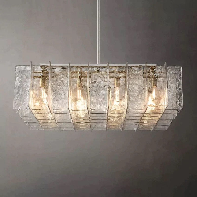 Crafted of solid cast glass, our Lattice collection's interlocking planes recall the geometric precision of the mid-century International Style. A study in repetition and rhythm, the linear form employs open space to lend a weightless feel. Gently rounded corners on the fluid, rippled panes subtly soften the outline, while diffused light glows from within.